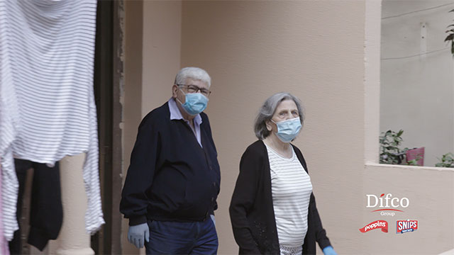 screen shot from CSR video of old couple wearing safety masks